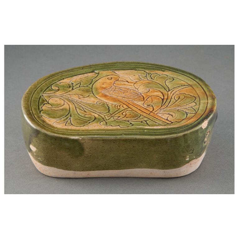 A Chinese Green and Yellow Glazed Carved Ceramic Pillow, Liao Dynasty